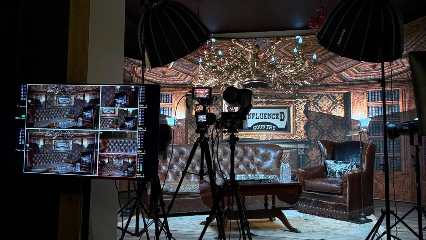 A talk-show set on the Stardust Studios LED wall stage, with leather chairs and cameras on tripods